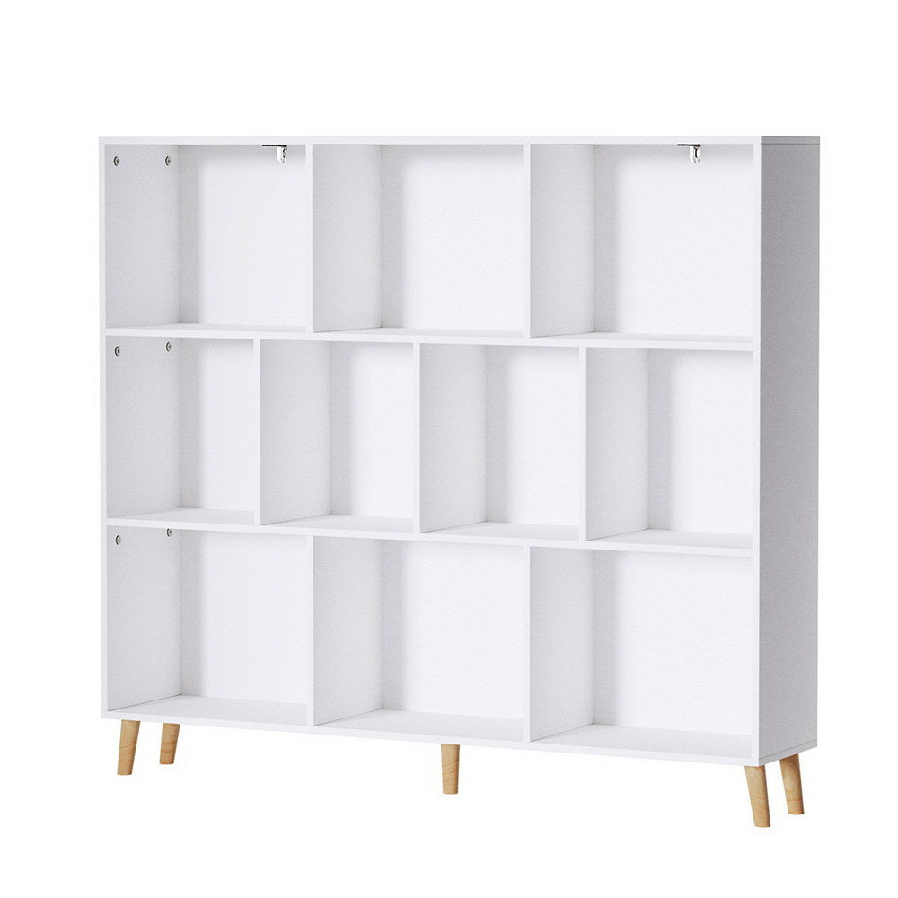 White 9-compartment cube bookshelf on four angled natural wood legs, angle view on white background