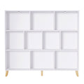 White 9-compartment cube bookshelf on four angled natural wood legs, front view on white background