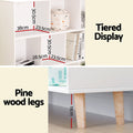 Cube bookshelf detail panel showing compartment sizes 38x23.5x30.5cm, tiered display layout and 11cm pine wood legs