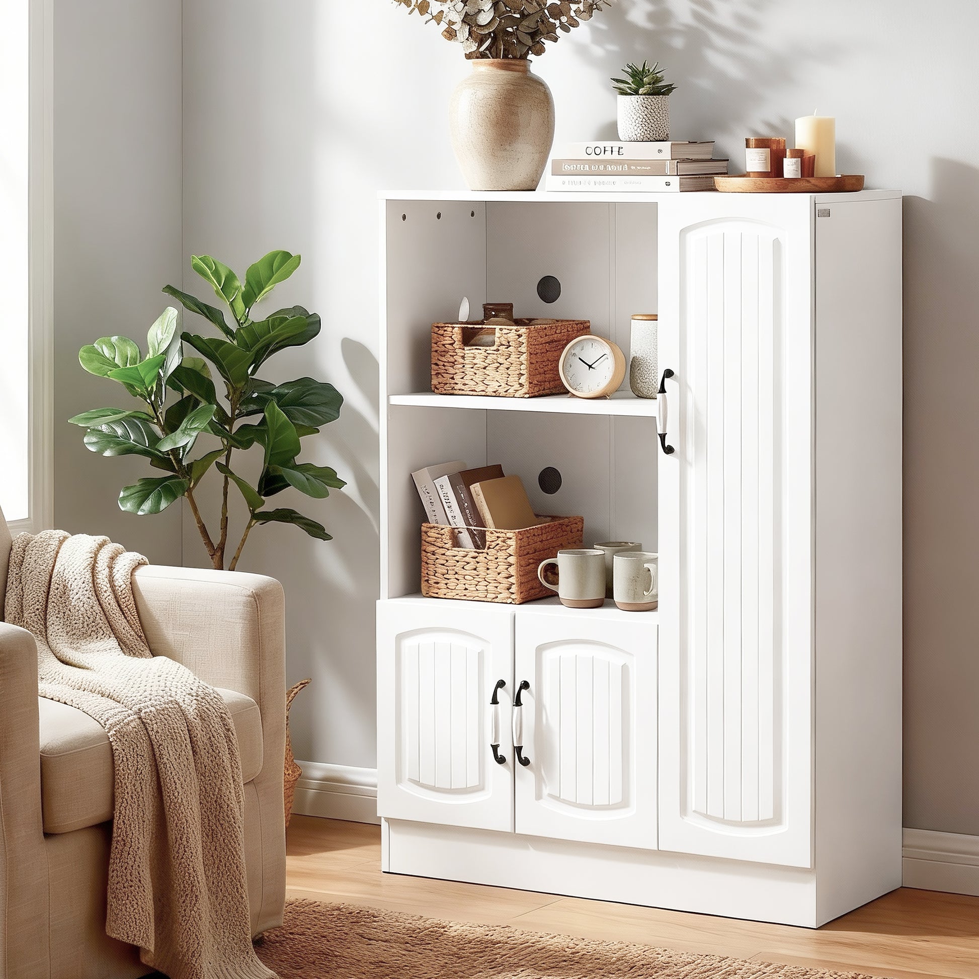 White display cabinet in living room with wicker baskets and clock on shelves, top styled with vase and plants
