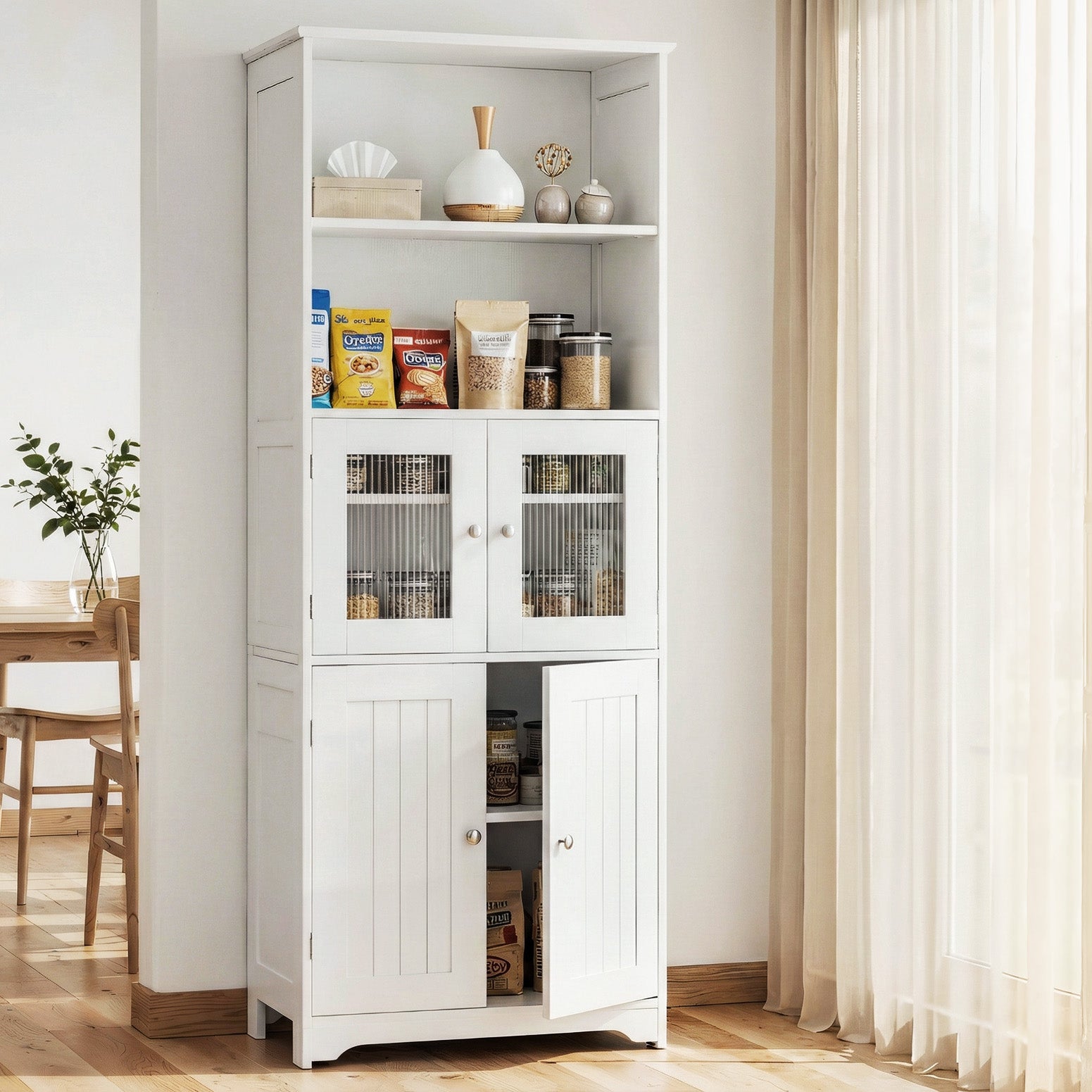 White display hutch cabinet in dining room with lower door ajar showing condiments, snack packets on open shelves
