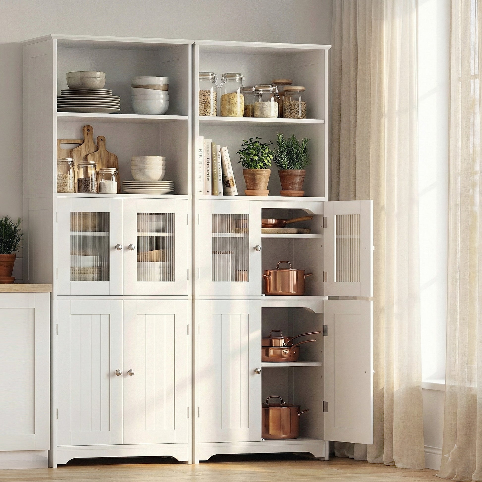 Two white display hutch cabinets in kitchen with right unit fully open showing copper pans and pantry storage