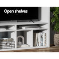 White entertainment unit open shelves lifestyle close-up showing books router and decorative items