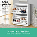 White flip-down shoe cabinet both doors open showing 24 pairs storage capacity with shoes loaded