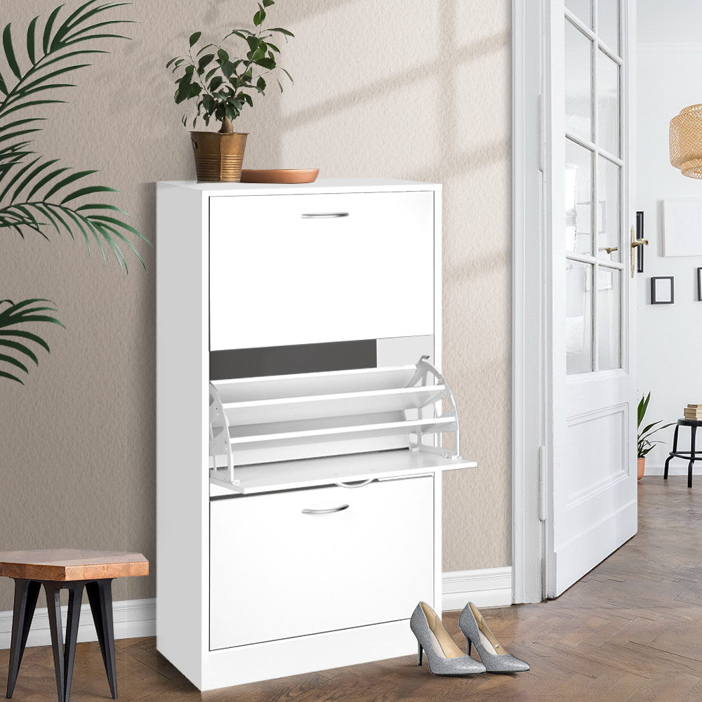 White 3-door flip shoe cabinet in hallway with French doors background, middle door open, heels beside