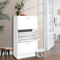 White 3-door flip shoe cabinet in hallway with French doors background, middle door open, heels beside