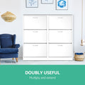 Two white 3-door flip shoe cabinets side by side next to blue armchair, doubly useful caption