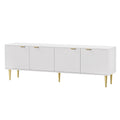 White TV unit on white background angled view 4 fluted doors gold bar handles and 6 gold tapered metal legs