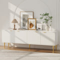 White 180cm TV unit with 4 fluted ribbed doors gold bar handles and gold tapered legs with art and lamp