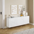 White gloss buffet with geometric line doors and gold hairpin legs in room, abstract art and cherry blossom vase on top