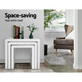 Three white nesting tables stacked together with books and vase on top, text reads Space-saving Kept within itself