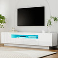 White glossy LED TV unit 180cm lifestyle in arched white room with blue LED two side doors two center drawers and plant