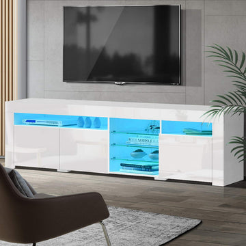 White glossy LED TV unit 180cm in living room with blue LED illuminating glass shelves and vases on top