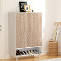 White shoe cabinet with herringbone oak doors and open bottom shelf in entryway with umbrella stand