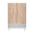 White shoe cabinet with two herringbone oak doors and open bottom shelf on white legs, front view