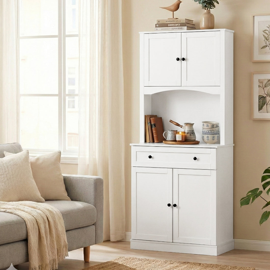 White two-piece kitchen hutch cabinet with shaker doors, arched niche, one drawer and black knobs on white background