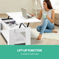 White lift-top coffee table angled three-quarter view with lower shelf visible