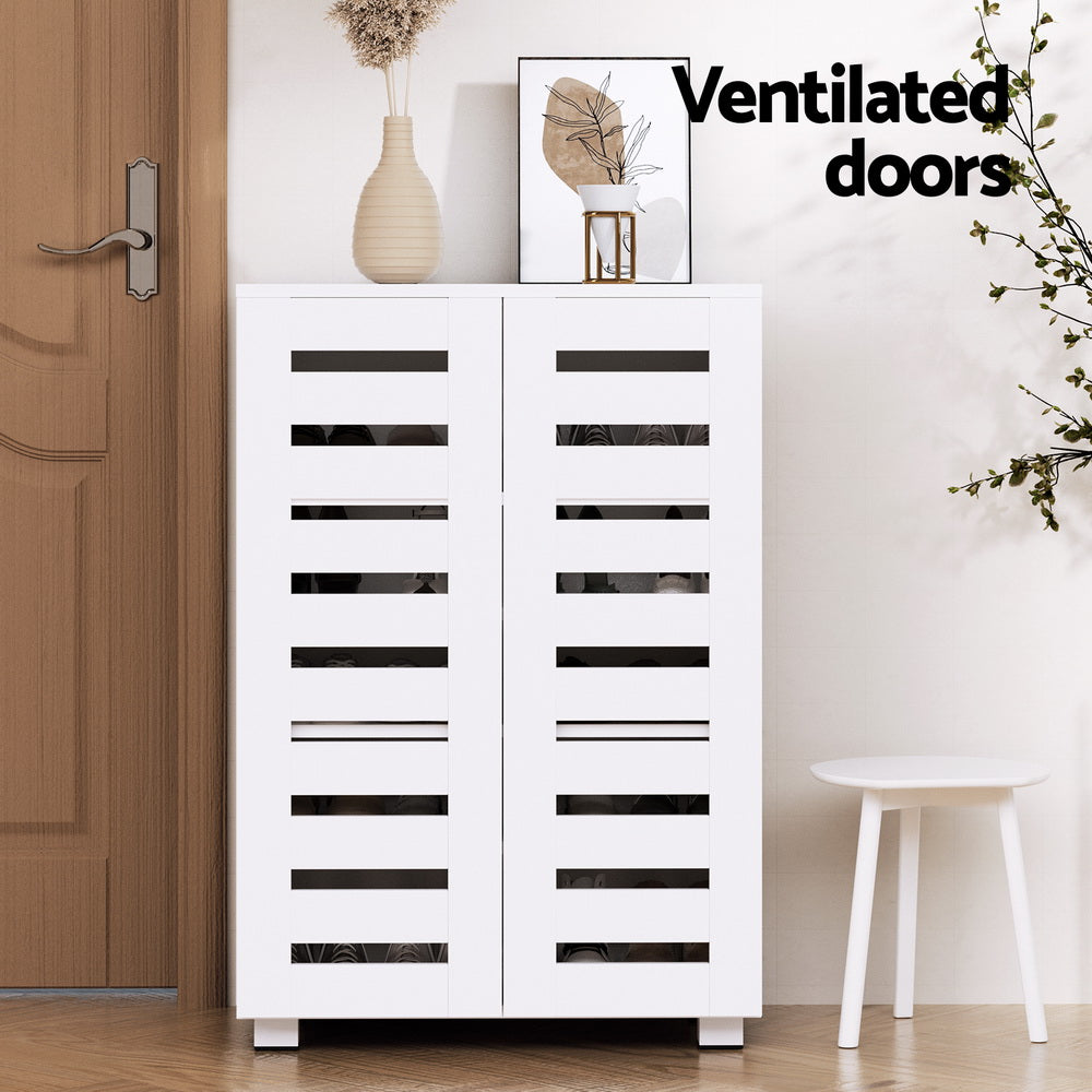 White louvred shoe cabinet in hallway with Ventilated doors text vase on top and round white stool