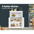 White louvred sideboard with doors open storing jars in kitchen; text: a better kitchen, everything in perfect order
