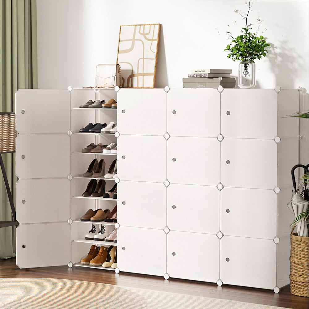 White modular 16-cube shoe cabinet in room with one column open showing shoe shelves, plants on top