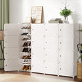 White modular 16-cube shoe cabinet in room with one column open showing shoe shelves, plants on top