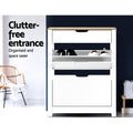 White oak top shoe cabinet upper tray open with black and white shoes clutter-free entrance text blue wall rattan chair