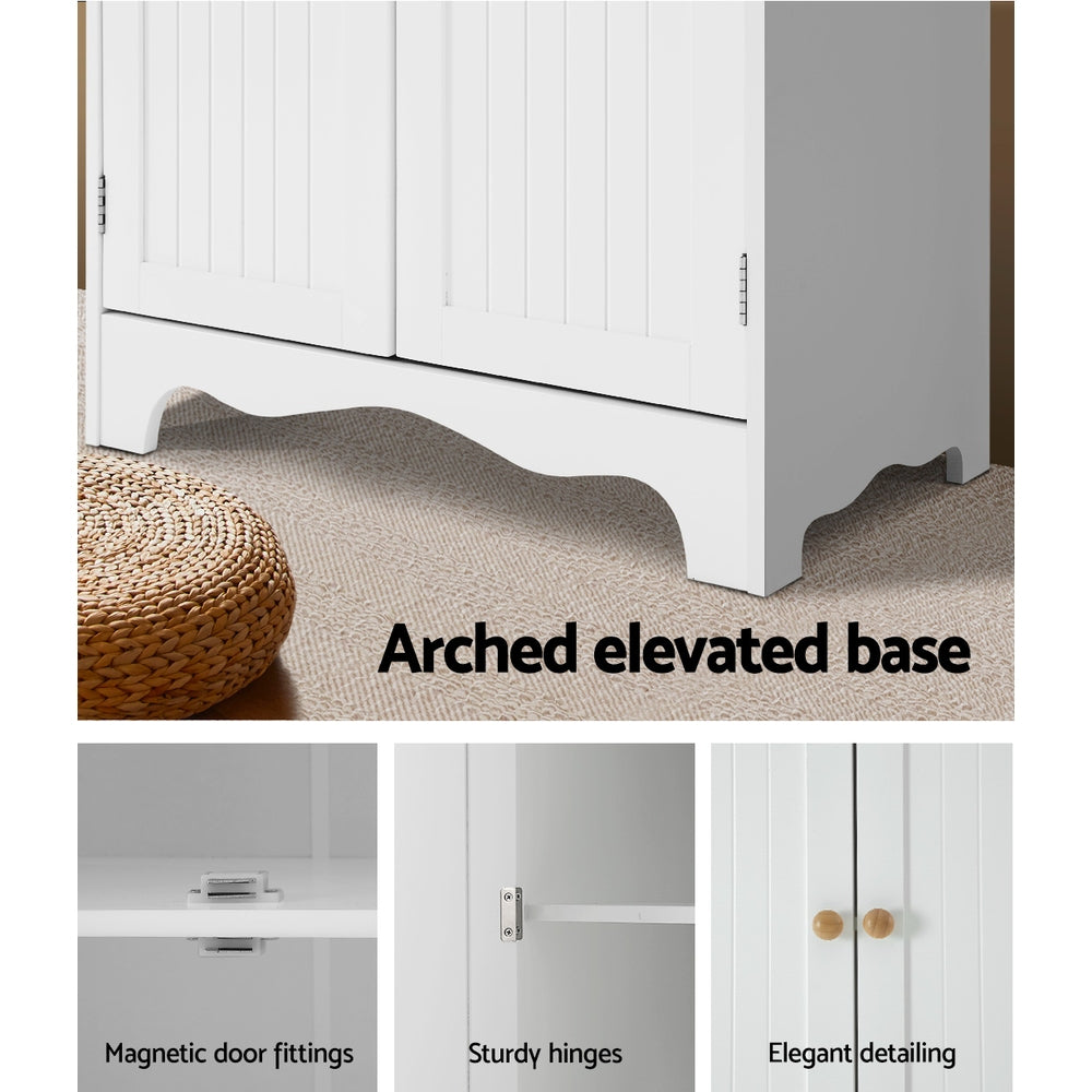 White pantry cabinet features: arched scalloped base, magnetic door fittings, sturdy hinges, round wood knob detail