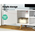 White Scandi TV unit cabinet door open with magnetic catch and wicker basket inside on angled pine legs