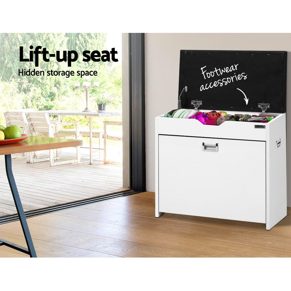 White shoe bench with black lid fully raised showing hidden storage compartment filled with footwear accessories