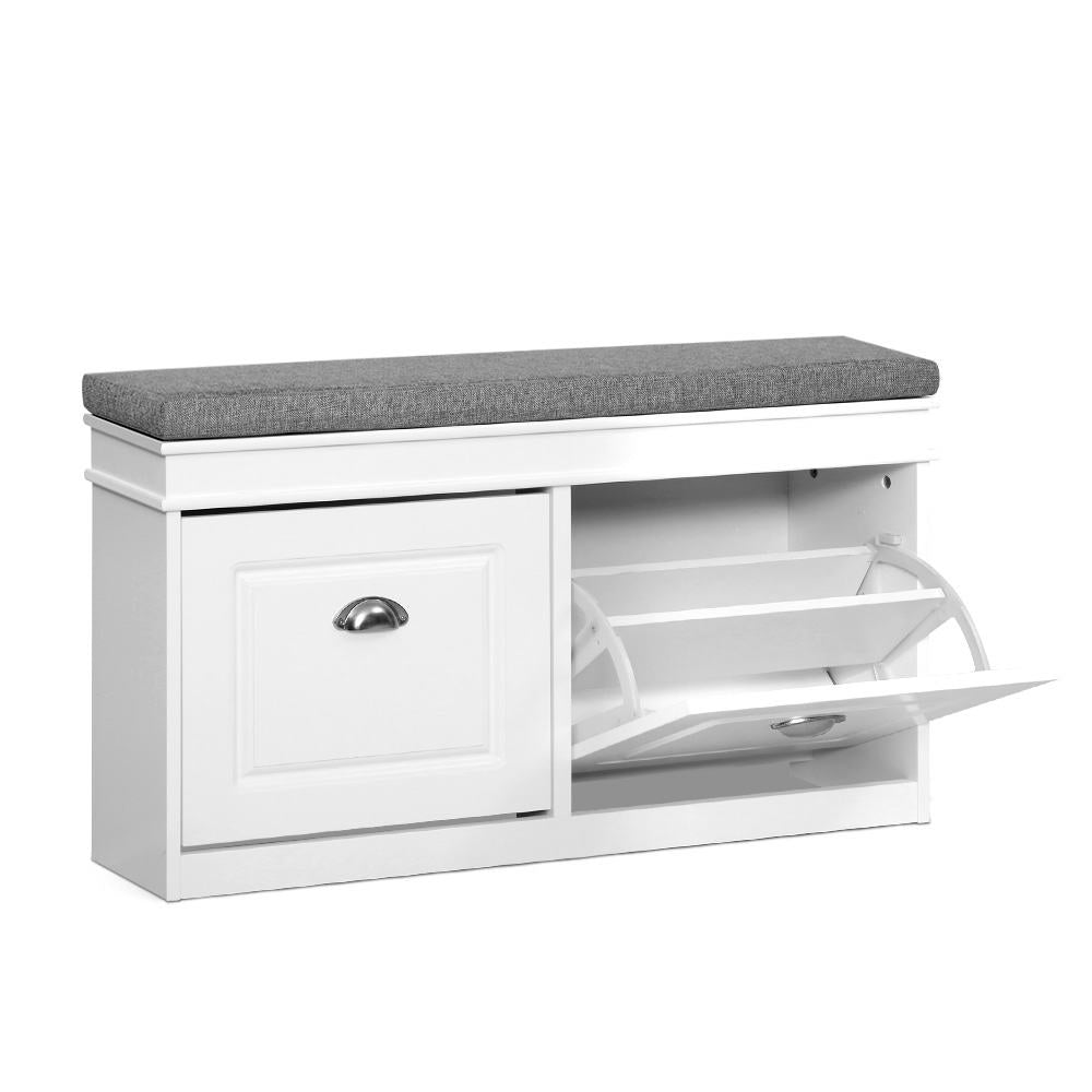 White shoe bench three-quarter view grey cushion on top left door closed right compartment open showing empty flip-out trays