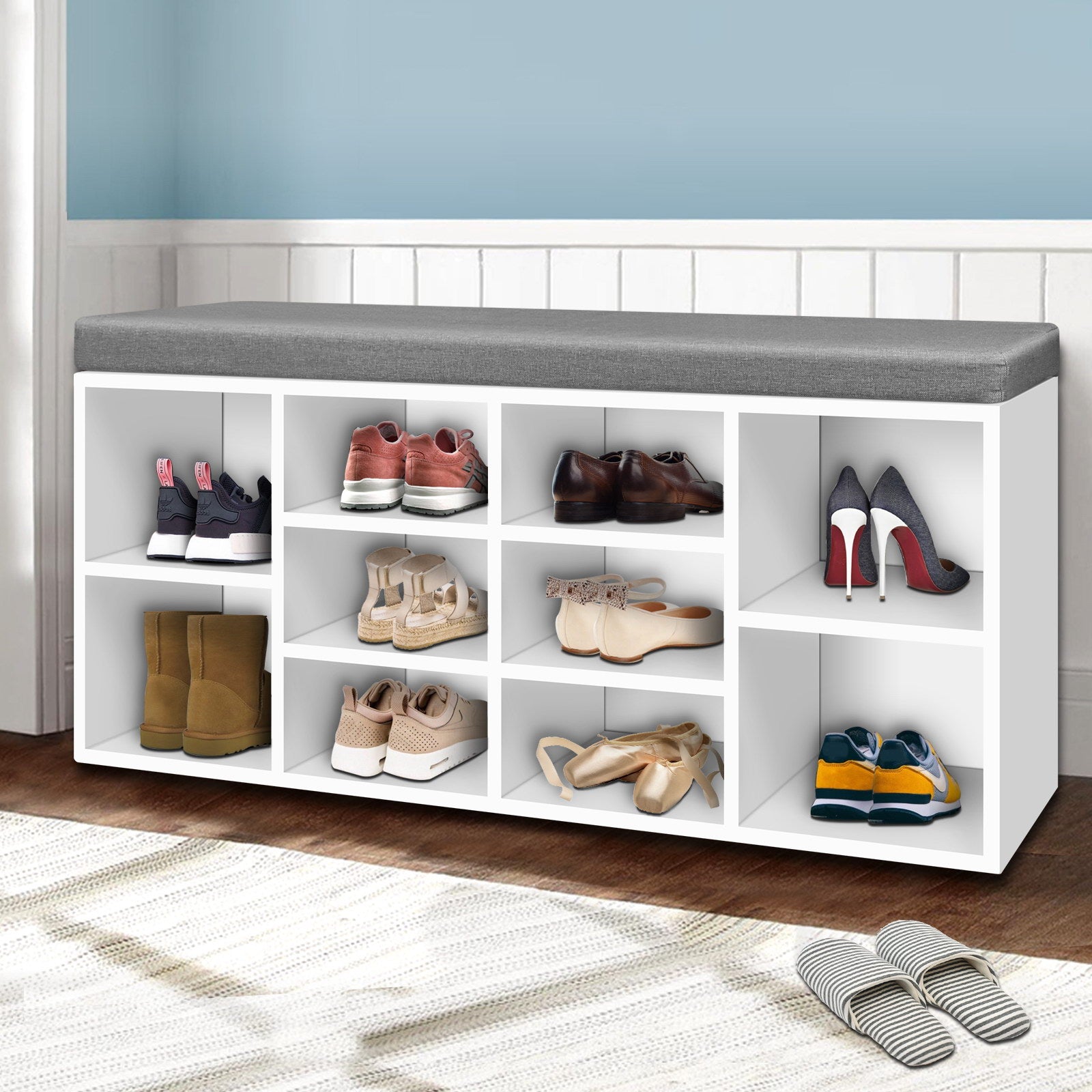 White shoe bench grey cushion with boots heels ballet flats and sneakers in hallway lifestyle with blue wall wainscot
