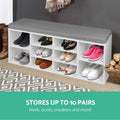 White shoe bench grey cushion loaded with boots heels and sneakers stores up to 10 pairs teal text dark grey wall hallway