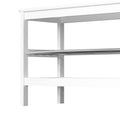 Close-up of white bamboo shoe bench corner showing wood frame edge and metal slatted shelf above