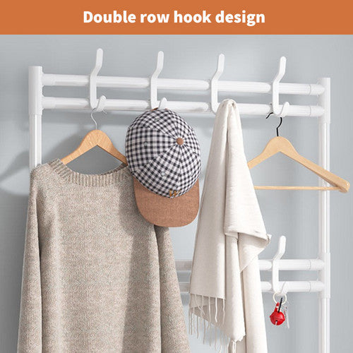 Close-up of white double row hooks on shoe hat stand holding sweater baseball cap towel and keys