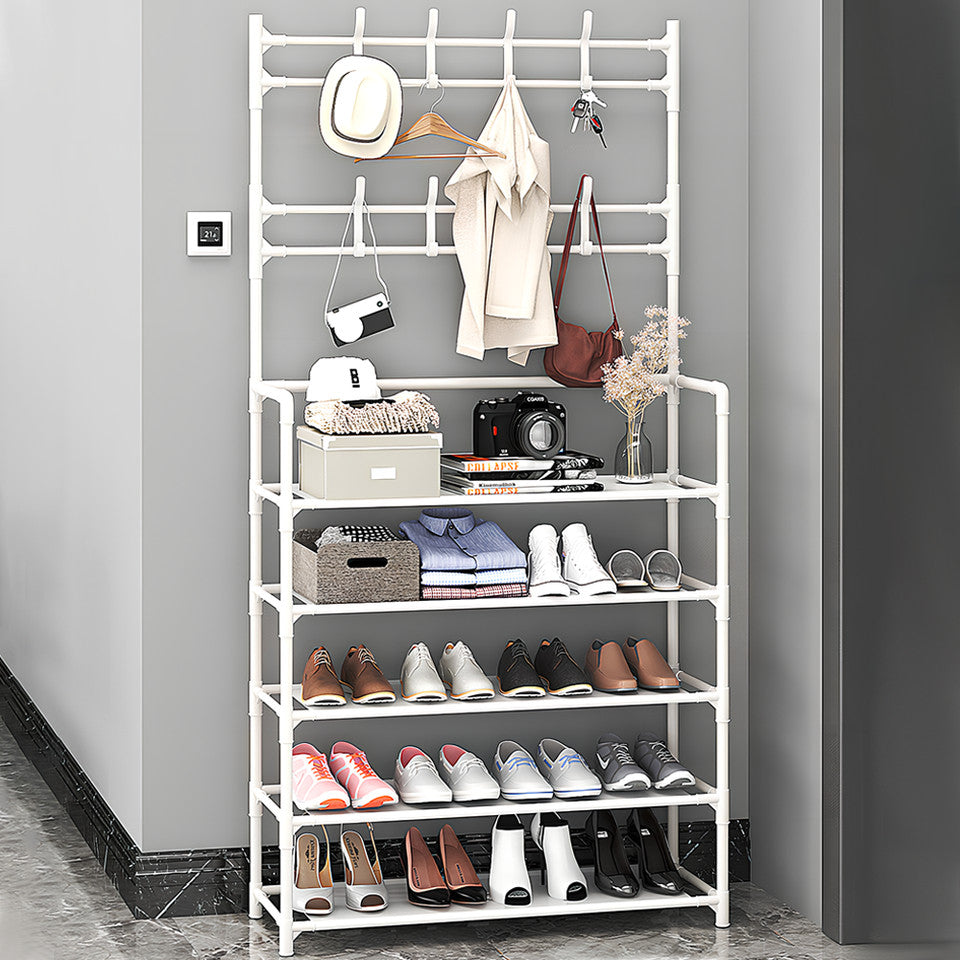 White shoe and hat stand fully loaded with shoes clothes hat bag and camera in grey entryway with marble floor