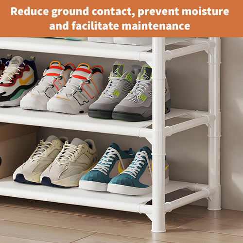 White shoe and hat stand fully loaded with shoes clothes hat bag and camera in grey entryway with marble floor