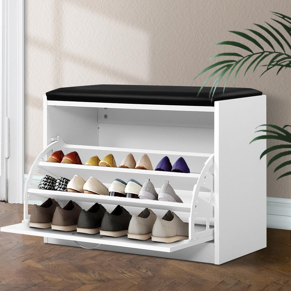 White shoe storage bench black PU seat cushion 3 tilting shelves deployed loaded with heels and flats in room