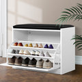 White shoe storage bench black PU seat cushion 3 tilting shelves deployed loaded with heels and flats in room