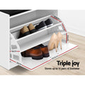 White shoe storage bench close-up of three tilting shelves loaded with heels and loafers shelf spacings annotated