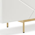 Close-up of white gloss sideboard lower corner with geometric faceted door and brass-finish metal legs with rubber feet