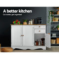 White sideboard with right cabinet open in kitchen, fruit bowl and coffee machine on top; text: a better kitchen