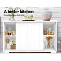 White sideboard with open shelves storing jars in kitchen; text: a better kitchen, everything in perfect order