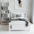 White single bed frame with panel headboard in bedroom lifestyle setting with grey throw blanket and asymmetric bookshelf