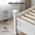 White single bed frame close-up showing solid wood slats and corner post with icons labeled Durable Eco-Friendly Comfortable