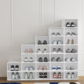 White clear-front stackable shoe boxes 24-pack arranged in staircase pattern loaded with shoes against molding wall
