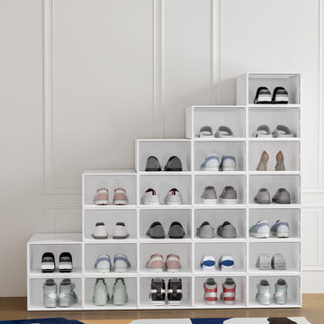 White clear-front stackable shoe boxes 24-pack arranged in staircase pattern loaded with shoes against molding wall