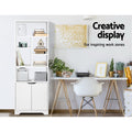 White tall bookcase with cabinet in home office lifestyle, text reads Creative display For inspiring work zones