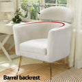 White teddy armchair in room with rug, white desk and lamp; 