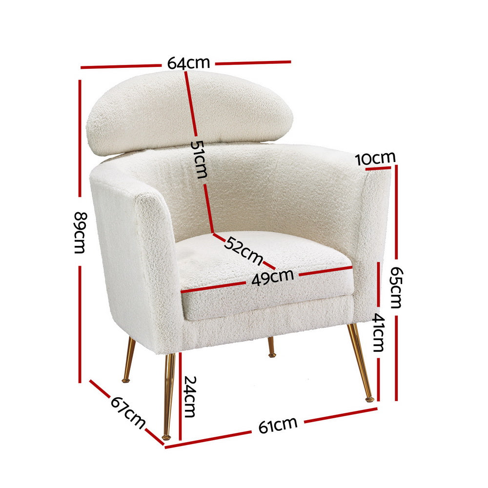White teddy fabric barrel armchair with oval headrest pillow and gold metal legs, room with marble side table and flowers
