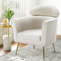 White teddy fabric barrel armchair with oval headrest pillow and gold metal legs, room with marble side table and flowers